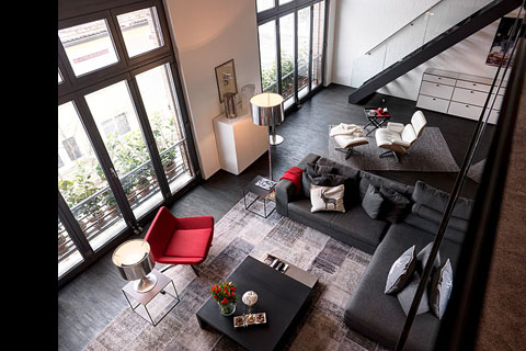 interior view from above on living room, red chair two black sofas