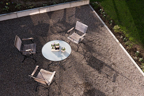 view from above on the patch (gravel) three lawn chairs and a round table
