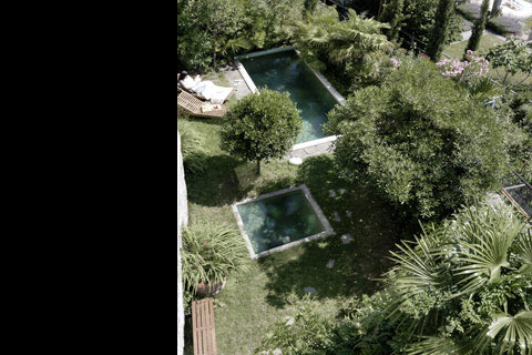sunny day, view from above on the two pools and plants